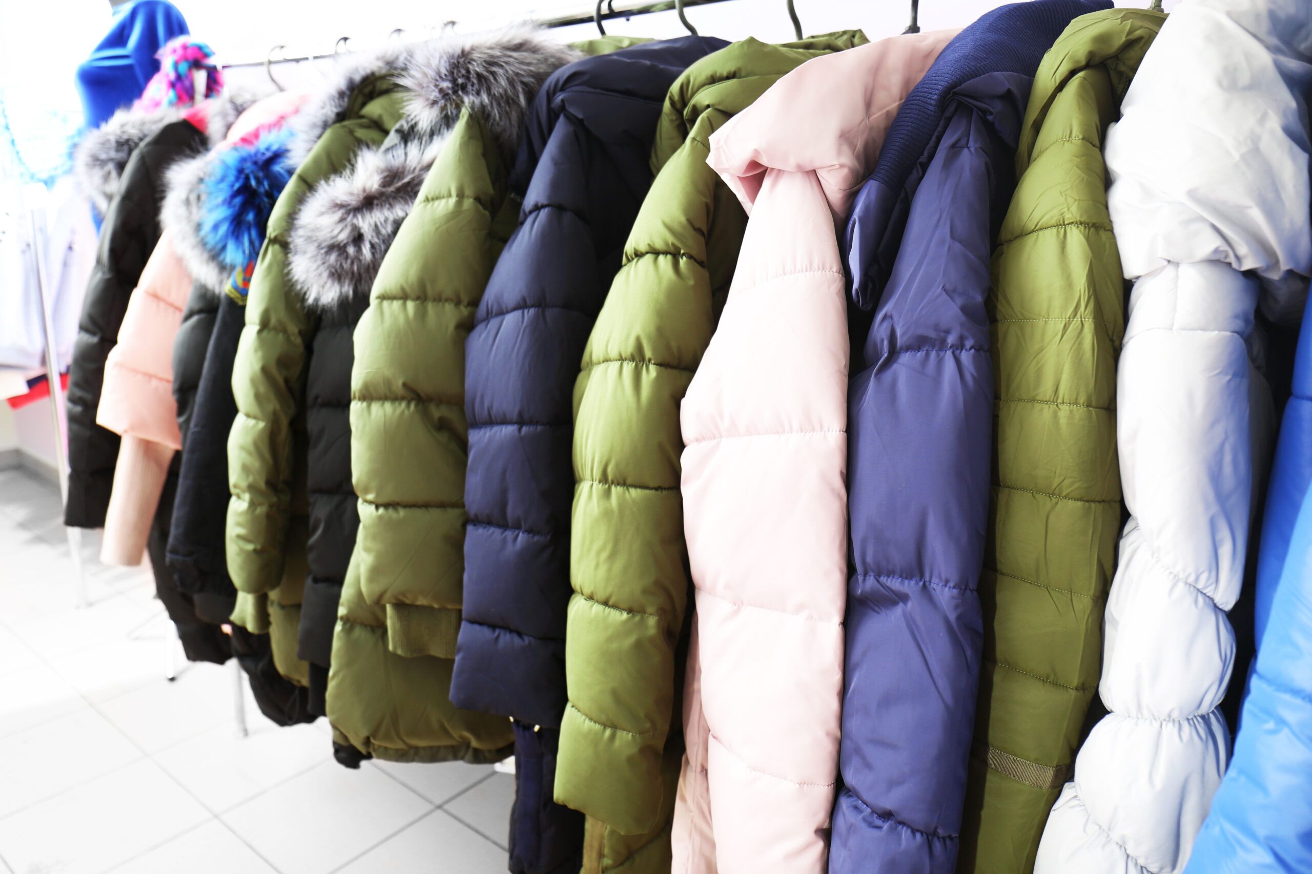 Winter clothes on hangers in modern shop